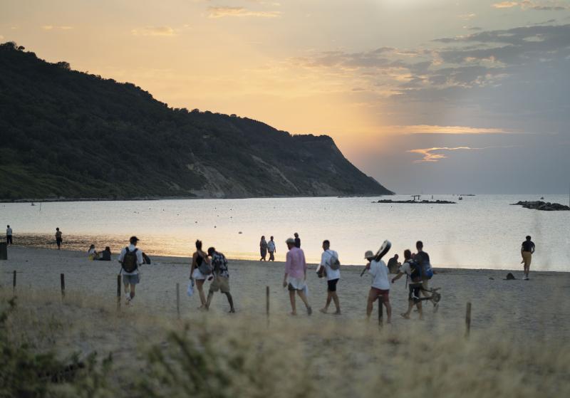 Beachcombers at the Lido Pavarotti in Pesaro